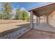 Large covered patio area with ceiling fan, great for entertaining; adjacent to low-maintenance gravel backyard at 10311 Slope Ridge St, Las Vegas, NV 89131