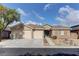 Charming single-story home with three-car garage, desert landscaping and a beautiful tile roof at 10311 Slope Ridge St, Las Vegas, NV 89131