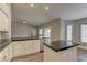 Kitchen features a black countertop island, white cabinets, and a view to the backyard at 10311 Slope Ridge St, Las Vegas, NV 89131