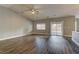 Spacious living room with ceiling fan, wood-look floors and sliding glass doors to backyard at 10311 Slope Ridge St, Las Vegas, NV 89131