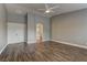 Spacious main bedroom with wood-look flooring, ceiling fan, and ensuite bathroom access at 10311 Slope Ridge St, Las Vegas, NV 89131