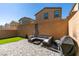 Private backyard features a paved patio, artificial grass, and cozy outdoor seating area perfect for entertaining at 10939 Cheshire Woods Ave, Las Vegas, NV 89166