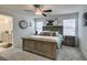 Bedroom features a ceiling fan, large bed, two windows, and wall decor at 10939 Cheshire Woods Ave, Las Vegas, NV 89166