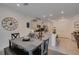 Light-filled dining room features modern table set and decor adjacent to an open kitchen at 10939 Cheshire Woods Ave, Las Vegas, NV 89166