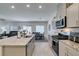 Modern kitchen with granite island opens to dining and living areas at 10939 Cheshire Woods Ave, Las Vegas, NV 89166