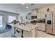 Bright open kitchen with granite island, stainless appliances, and breakfast nook at 10939 Cheshire Woods Ave, Las Vegas, NV 89166