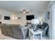 Comfortable living room featuring tile floors, lots of seating, and modern fixtures at 10939 Cheshire Woods Ave, Las Vegas, NV 89166