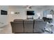 Cozy living room showcasing a gray sectional, tile floors, and modern decor at 10939 Cheshire Woods Ave, Las Vegas, NV 89166