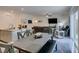 Open layout with dining area and living room, showcases a modern kitchen with stainless appliances at 10939 Cheshire Woods Ave, Las Vegas, NV 89166