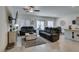 Open-concept living room featuring neutral tones, tile flooring, and abundant natural light at 10939 Cheshire Woods Ave, Las Vegas, NV 89166