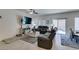 Spacious living room featuring tile flooring, ample seating, and sliding glass doors at 10939 Cheshire Woods Ave, Las Vegas, NV 89166