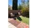 Manicured backyard with patio seating area and putting green at 11201 Newbury Hills Ave, Las Vegas, NV 89138