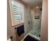 Beautiful walk-in shower with marble tile surround and hexagonal tile base at 11201 Newbury Hills Ave, Las Vegas, NV 89138
