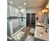 Stunning bathroom featuring a walk-in shower with dual vanity sinks and modern finishes at 11201 Newbury Hills Ave, Las Vegas, NV 89138