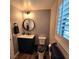 Cozy powder room with dark vanity, modern fixtures and shuttered window at 11201 Newbury Hills Ave, Las Vegas, NV 89138