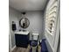 Comfortable half bath features dark vanity, modern fixtures and shuttered window at 11201 Newbury Hills Ave, Las Vegas, NV 89138