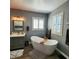 A luxurious bathroom featuring a freestanding tub, vanity with sink, and modern fixtures at 11201 Newbury Hills Ave, Las Vegas, NV 89138