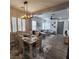 Stylish dining room open to the living area, featuring a modern chandelier and seating for six at 11201 Newbury Hills Ave, Las Vegas, NV 89138