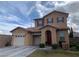 Charming home with a two-car garage, neutral stucco, and a red front door adding a pop of color at 11201 Newbury Hills Ave, Las Vegas, NV 89138