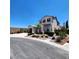 Two-story residence featuring a two-car garage, complemented by meticulous landscaping and mature trees at 11201 Newbury Hills Ave, Las Vegas, NV 89138