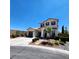 Inviting two-story house showcasing a dual-car garage, stone walkway, and neatly arranged landscaping at 11201 Newbury Hills Ave, Las Vegas, NV 89138
