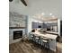 Stylish kitchen with stainless appliances, breakfast bar and adjacent fireplace with stone surround at 11201 Newbury Hills Ave, Las Vegas, NV 89138