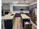 Spacious kitchen boasts stainless appliances, ample counter space, and a central island for cooking at 11201 Newbury Hills Ave, Las Vegas, NV 89138