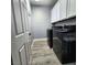 Laundry room featuring black washer and dryer and white cabinets at 11201 Newbury Hills Ave, Las Vegas, NV 89138