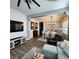Cozy living room with a dining area featuring wood-style flooring, neutral walls, and ample natural light at 11201 Newbury Hills Ave, Las Vegas, NV 89138