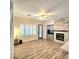 Living room features fireplace with stone surround, ample natural light and backyard access at 11201 Newbury Hills Ave, Las Vegas, NV 89138