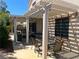 Covered patio featuring ample seating and dining space, complete with a grill and string lights at 11201 Newbury Hills Ave, Las Vegas, NV 89138