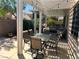 Spacious covered patio featuring an outdoor dining area and cozy seating area for entertaining at 11201 Newbury Hills Ave, Las Vegas, NV 89138