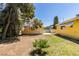 Lush backyard featuring a quaint house and private detached garage at 1127 Melville Dr, Las Vegas, NV 89102