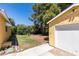 Backyard featuring a yellow storage shed, grass, and trees at 1127 Melville Dr, Las Vegas, NV 89102