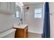 Bathroom with a white sink, bathtub, and blue shower curtain at 1127 Melville Dr, Las Vegas, NV 89102