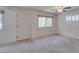 Spacious carpeted bedroom with natural light, neutral walls, a ceiling fan, and a serene ambiance at 1127 Melville Dr, Las Vegas, NV 89102