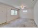 A roomy bedroom featuring neutral walls, carpeted floors, a ceiling fan, and natural light from the windows at 1127 Melville Dr, Las Vegas, NV 89102
