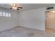 Large, carpeted bedroom features a ceiling fan, windows for natural light, and neutral-toned walls at 1127 Melville Dr, Las Vegas, NV 89102