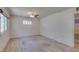 A spacious room showcasing neutral tones, carpeted floors, and a ceiling fan to keep it cool at 1127 Melville Dr, Las Vegas, NV 89102