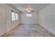 An expansive room featuring neutral walls, carpet flooring, and a ceiling fan for added comfort at 1127 Melville Dr, Las Vegas, NV 89102
