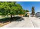 Quaint single-story house with a large carport, a cozy porch swing, and a well-maintained front lawn at 1127 Melville Dr, Las Vegas, NV 89102