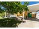 Charming single-story house with a covered carport, a bench swing on the porch, and mature trees at 1127 Melville Dr, Las Vegas, NV 89102