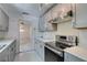 Contemporary kitchen features stainless appliances, sleek countertops, and access to adjacent living area at 1127 Melville Dr, Las Vegas, NV 89102