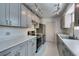 Updated kitchen with stainless steel appliances, modern gray cabinetry, and ample counter space at 1127 Melville Dr, Las Vegas, NV 89102