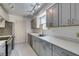 Updated kitchen with stainless steel appliances, gray cabinets, and lots of counter space at 1127 Melville Dr, Las Vegas, NV 89102