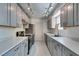 Modern kitchen with stainless steel appliances, gray cabinets, and ample lighting for a stylish cooking space at 1127 Melville Dr, Las Vegas, NV 89102