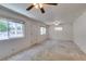 Open living space with neutral carpet, multiple windows, and ceiling fans for enhanced air circulation at 1127 Melville Dr, Las Vegas, NV 89102