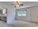 Bright living room features neutral carpeting, a ceiling fan, and a window for natural light at 1127 Melville Dr, Las Vegas, NV 89102