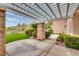 Back patio features stone columns, a pergola and artificial turf at 11527 Morning Grove Dr, Las Vegas, NV 89135