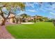 Lush backyard features artificial turf, desert landscaping and an expansive patio area at 11527 Morning Grove Dr, Las Vegas, NV 89135